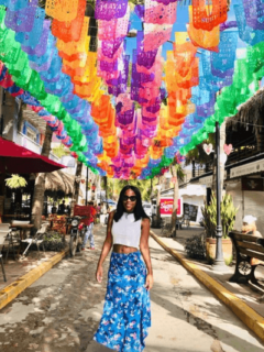 Woman walking under colorful flags
