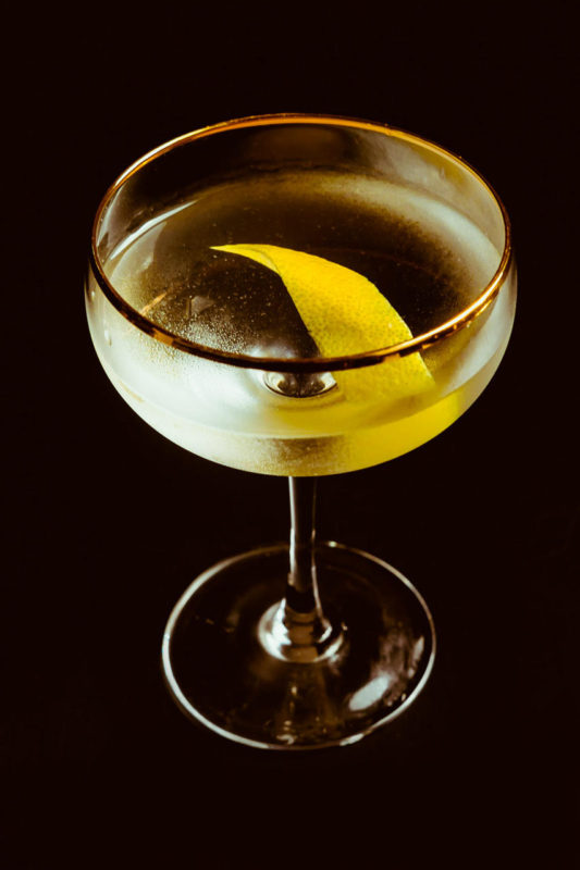 Cocktail in coupe with lemon peel