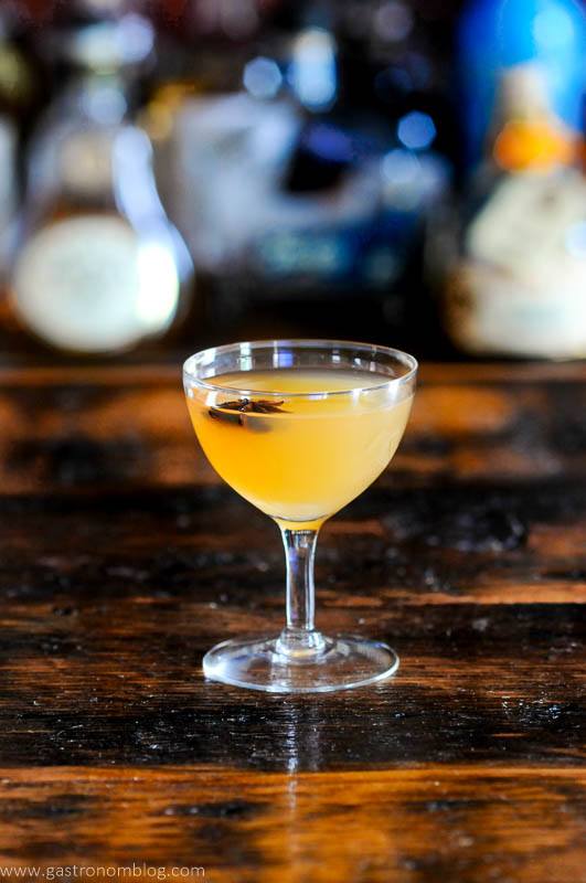 Yellow Scotch whisky cocktail in coupe with star anise garnish