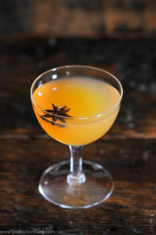 Scotch and apple cider cocktail in coupe with star anise garnish