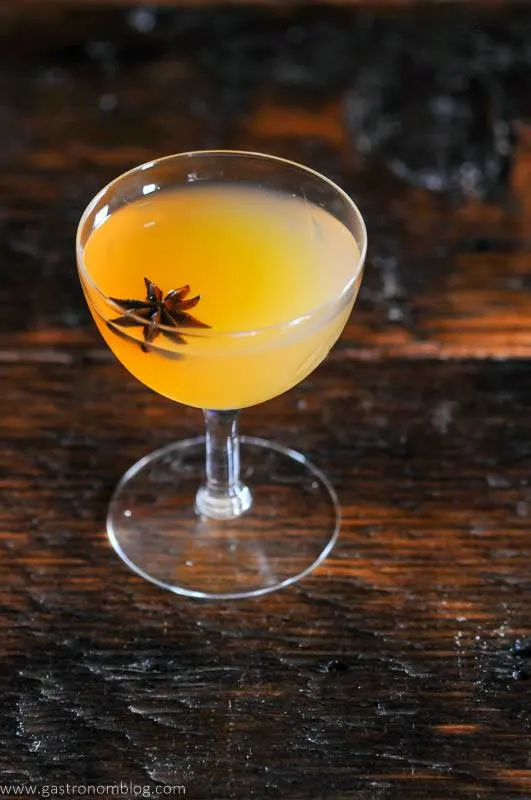 Yellow Scotch whisky cocktail in coupe with star anise garnish