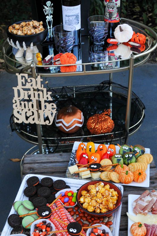 Halloween party ideas on plates with Halloween candy and healthy treats