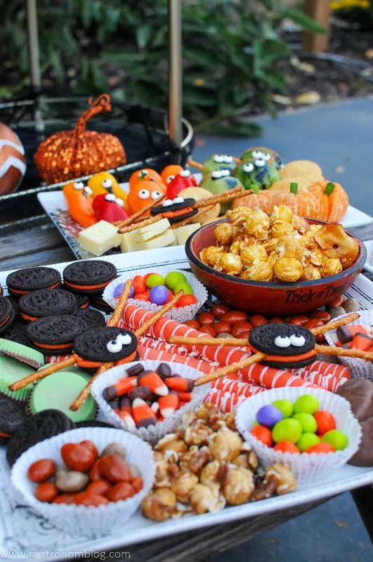 Halloween Charcuterie on plates with Halloween candy and healthy treats