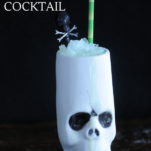 Skull tiki mug with green bamboo straw and skull pick