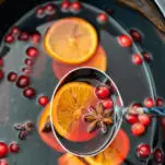 Slow cooker mulled wine with orange slices, cranberries and spices