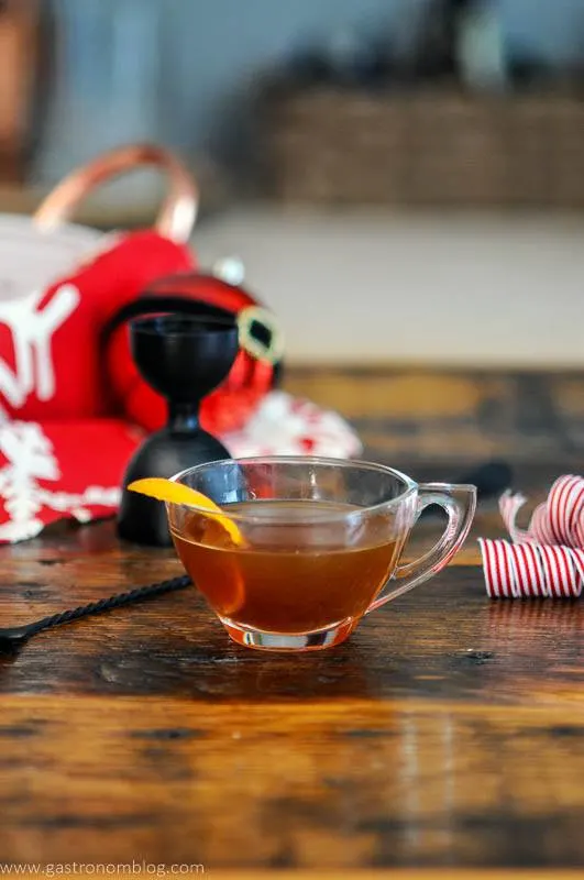 Hot Gin Toddy in tea cup with orange zest