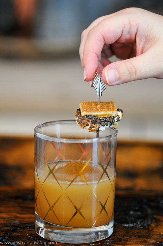 S'mores cocktail in gold etched glass, small s'more on garnish pick