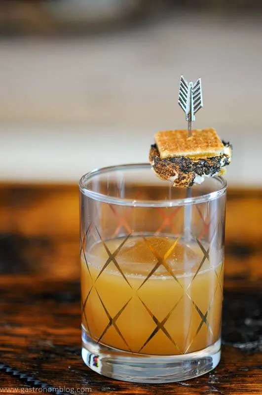 S'mores cocktail in gold etched glass, small s'more on garnish pick
