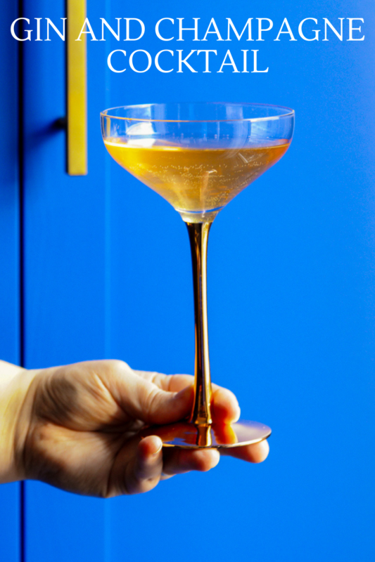gin and champagne cocktail in coupe, blue background