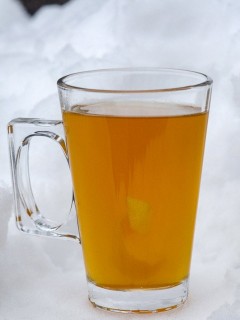 Cocktail in glass mug with handle in the snow