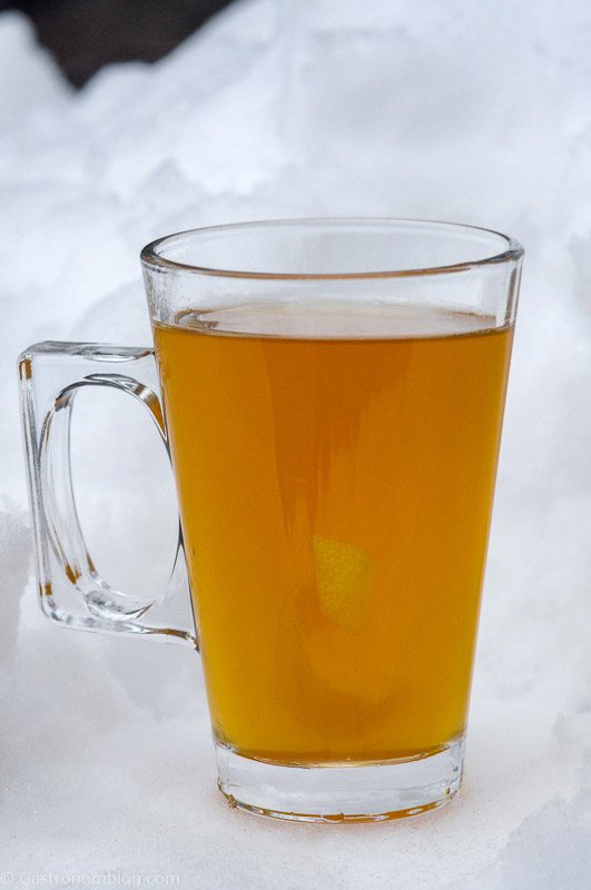 Cocktail in glass mug with handle in the snow