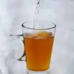 Cocktail in glass mug with handle in the snow