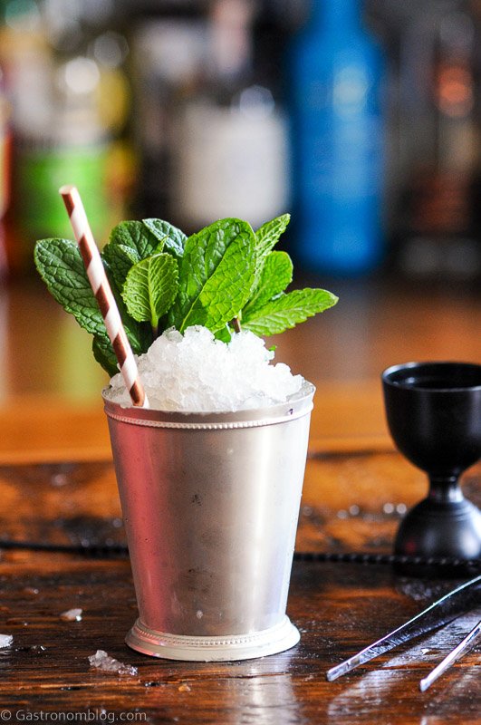 Chocolate Mint Julep in a silver cup with mint sprig and striped paper straw