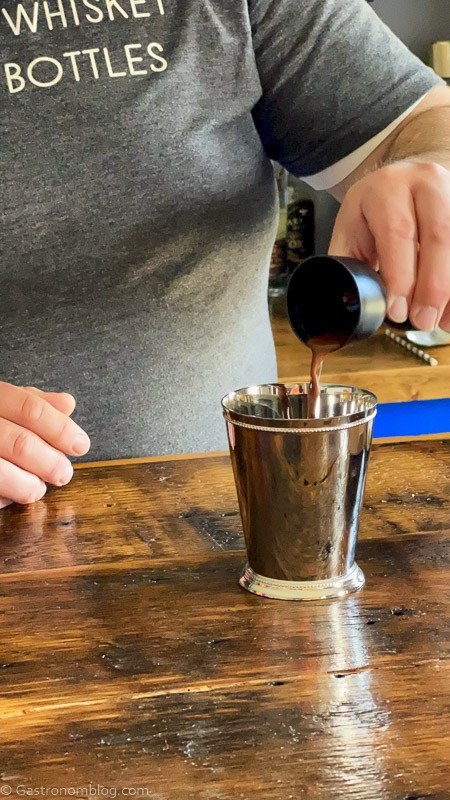 Pouring from a jigger to a silver cup