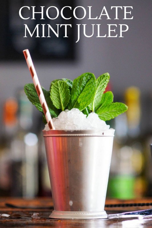 Chocolate Mint Julep in silver cup piled with crushed ice, mint sprig and striped paper straw