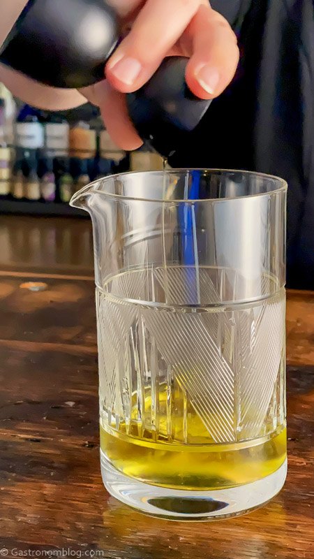 Yellow cocktail in mixing glass