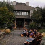 People seated in wooden adirondak chairs at Frog's Leap winery