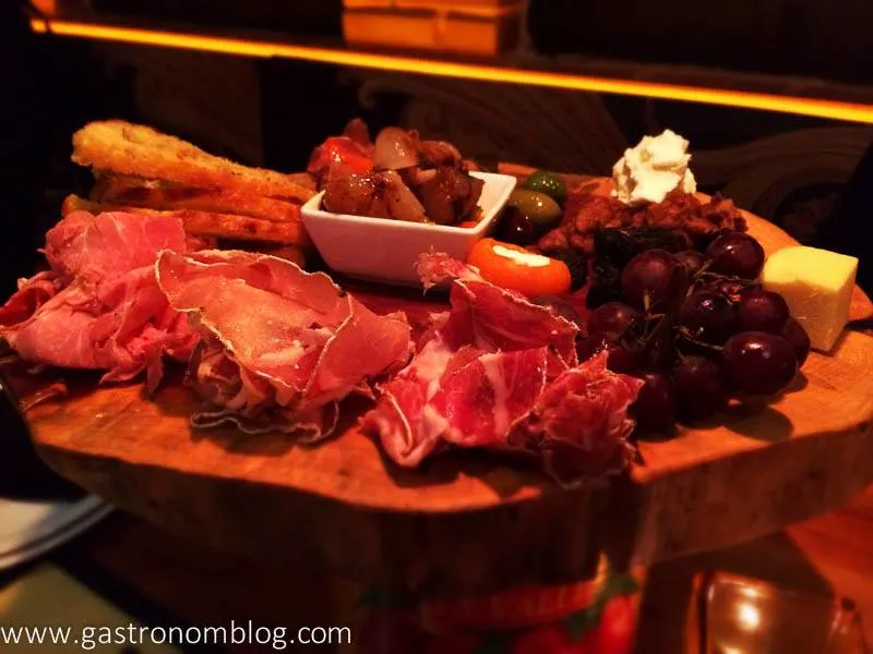 Charcuterie on a board with meat and grapes at Pitch Pizza Omaha