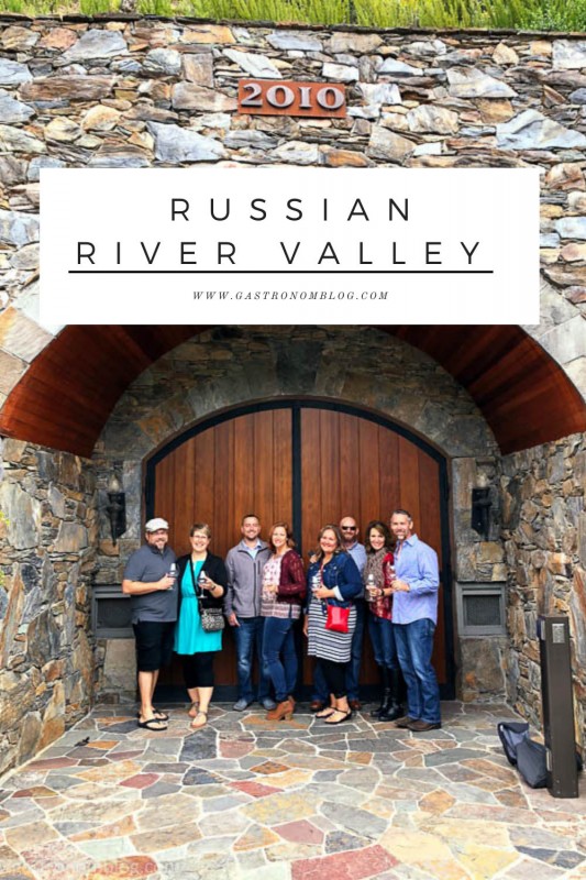 8 People standing in front of wooden doors of a Russian River Valley winery wine cave