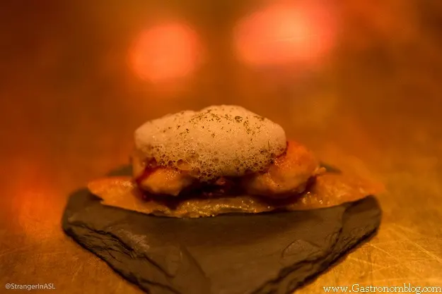 Chicken skin with foam on top at e by Jose Andres