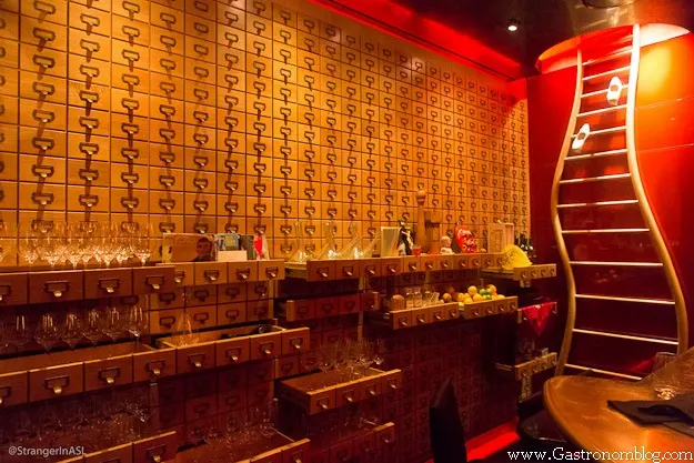Jose Andres Las Vegas has gold walls with drawers and shelves wtih ingredients, a wooden ladder