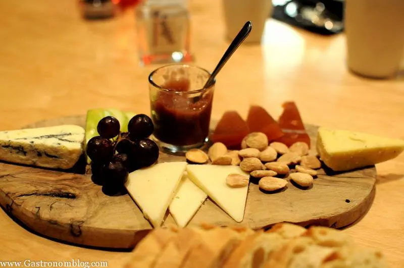 Cheese plate with nuts, cheese and berries