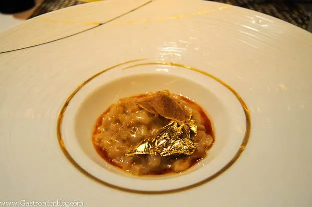 Farrow dish topped with gold leaf in gold rimmed white bowl at Robuchon Las Vegas