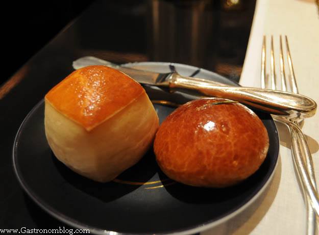 bread rolls on black plate with knife