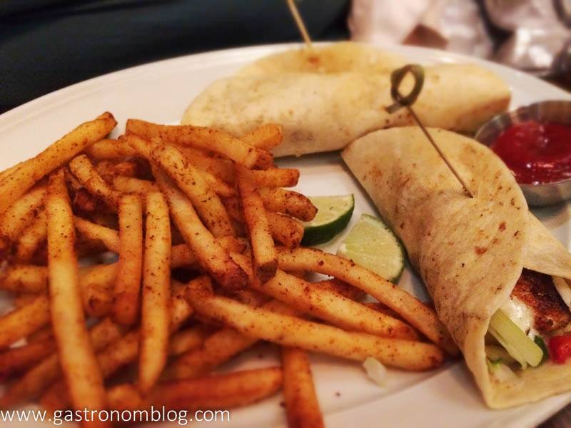 Tacos and fries on white plate