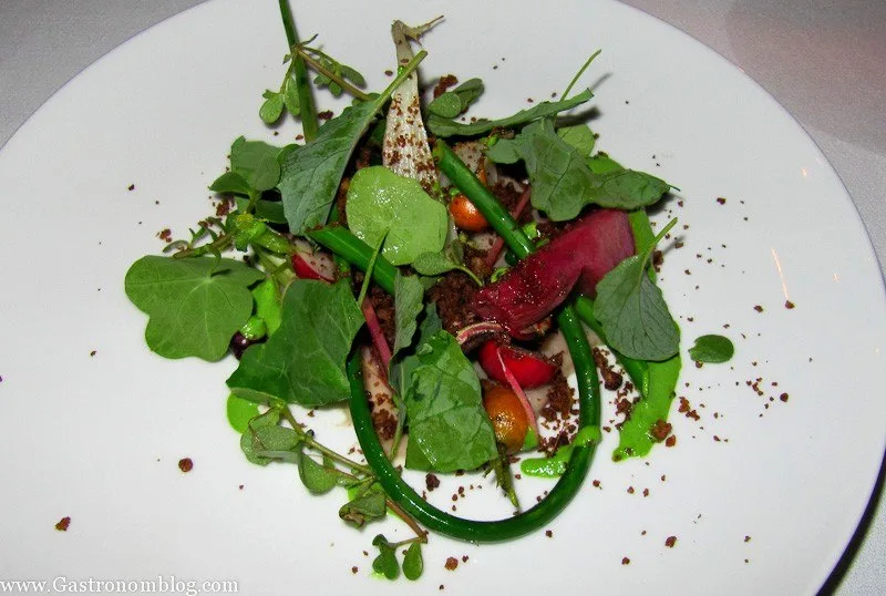 greens and veggies on a white plate at V Mertz Restaurant Omaha