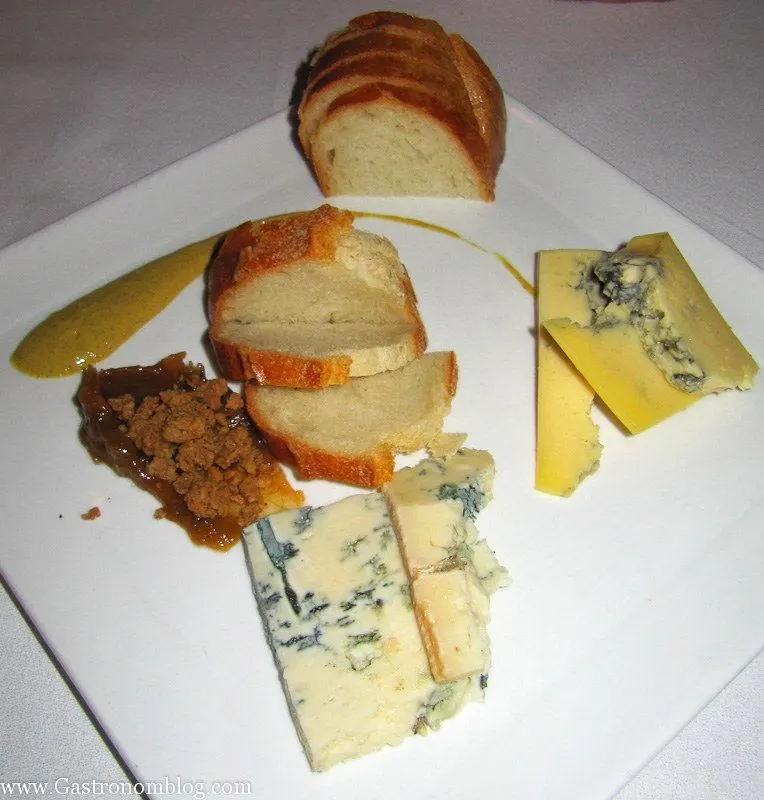 Cheeses and bread on white plate at V Mertz Restaurant Omaha