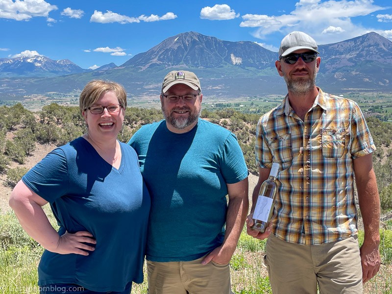Jay, Leah and Steve Steese in front of the mountains at The Storm Cellar Winery