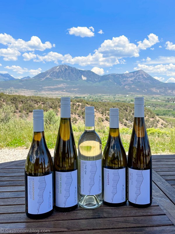5 bottles of wine at Storm Cellar Winery, mountains in background