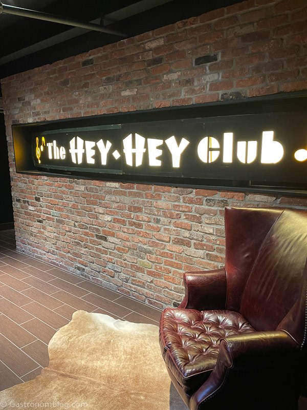 Sign of the Hey Hey Club lit up with lights