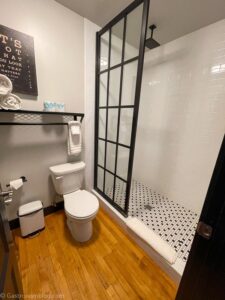 Bathroom at Hotel Grinnell, black and white tile, wood floors