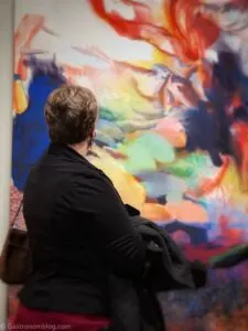 Back of woman looking at colorful artwork