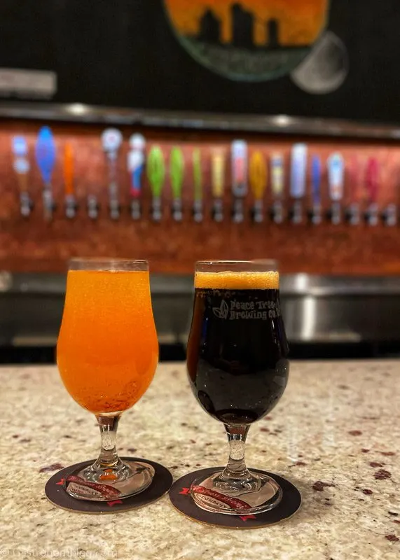 Stout Beer and Cider in glasses on bar, taps behind in Grinnell, Iowa