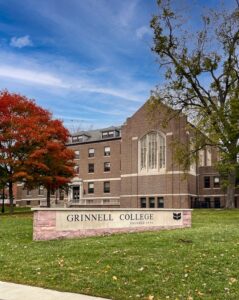 Grinnell College sign, building behind