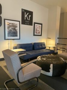 Sitting area in Penthouse suite of Hotel Grinnell, blue couch and gray chair