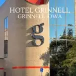 tan brick Hotel Grinnell, orange tile and black G Logo