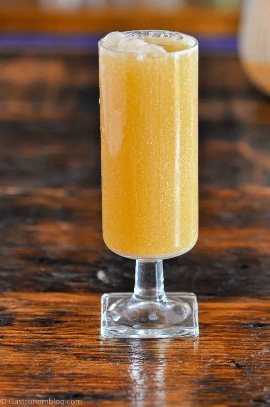 tan Caramel Apple Cider Mimosa cocktail with glitter swirls in tall glass