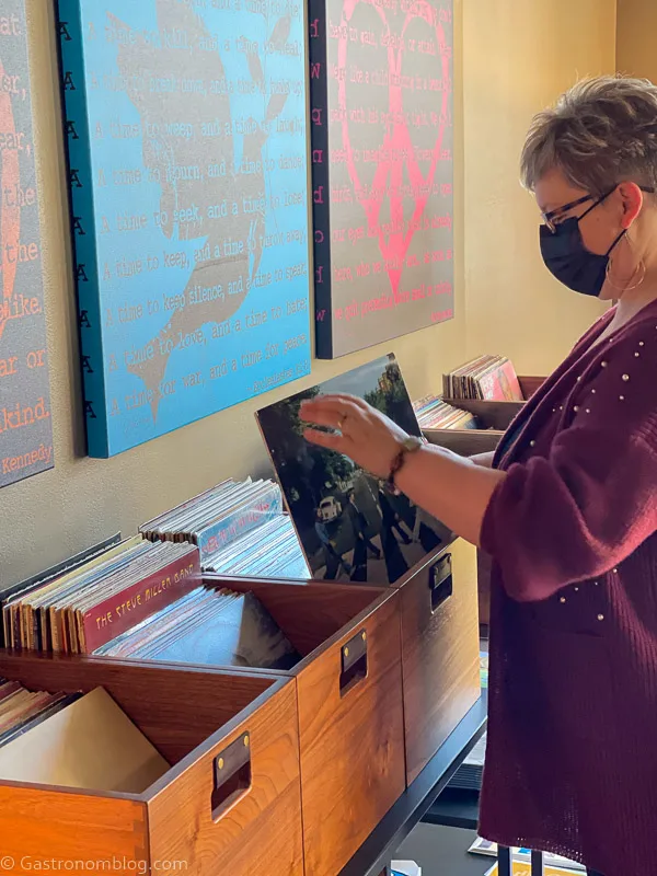 Woman in maroon sweater looking through records