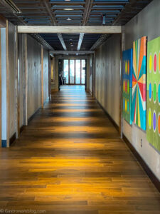 Look down long hallway with wooden floors