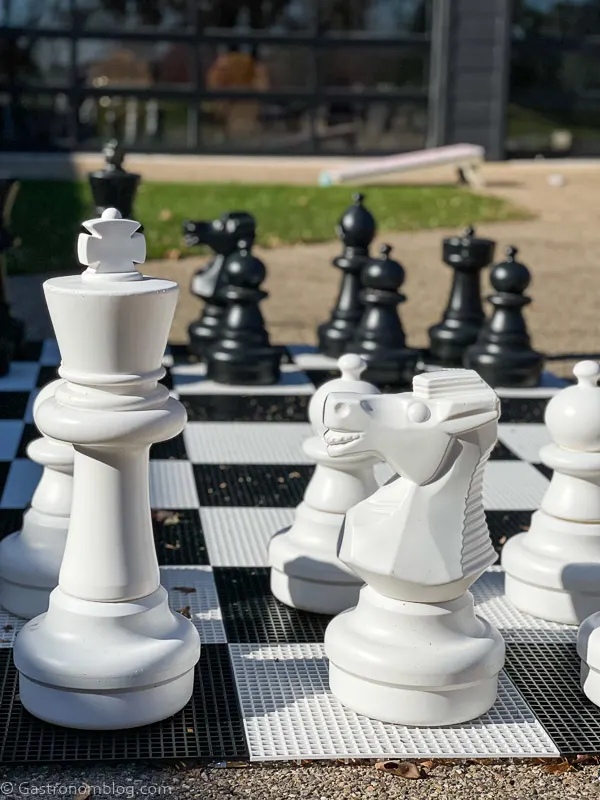 Large chess pieces on outdoor chess board