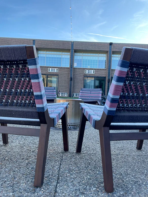 Striped outside chairs at a fire pit