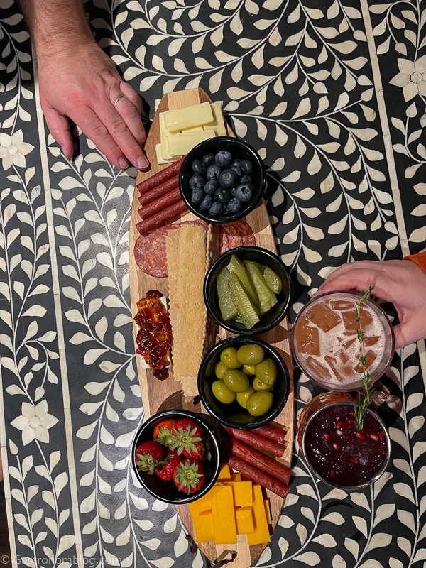 top shot of charcuterie board with meats, cheeses, pickles and berries