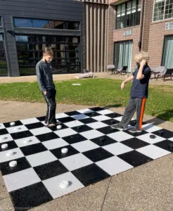 boys playing outdoor checkers