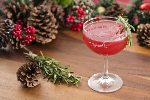 Pink drink with Christmas decor behind