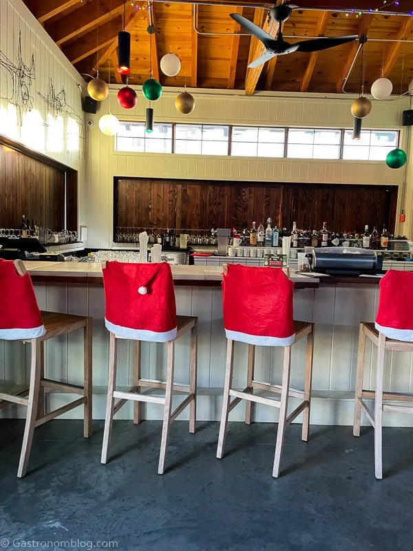 Santa hats on chairs at bar in Holiday Hut at Cottonwood Hotel
