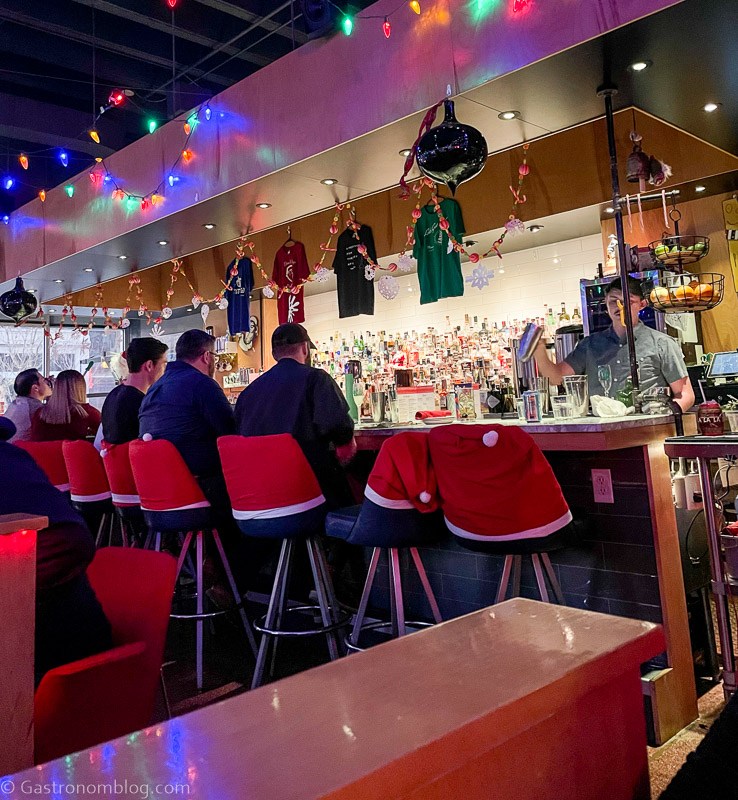 Mercury Christmas Pop Up Bar in Omaha, Santa hats on chairs, Christmas lights